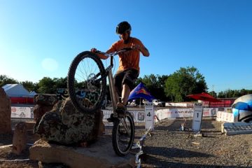 Freddy Astrada balances on a rock on the rear wheel of his trials bike