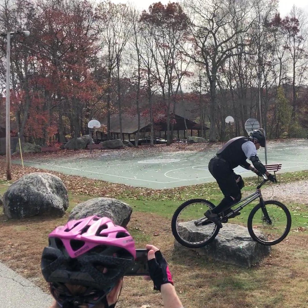 Frankie rides over a rock on his trials bike