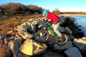 Jim straddles some boulders on his trials bike