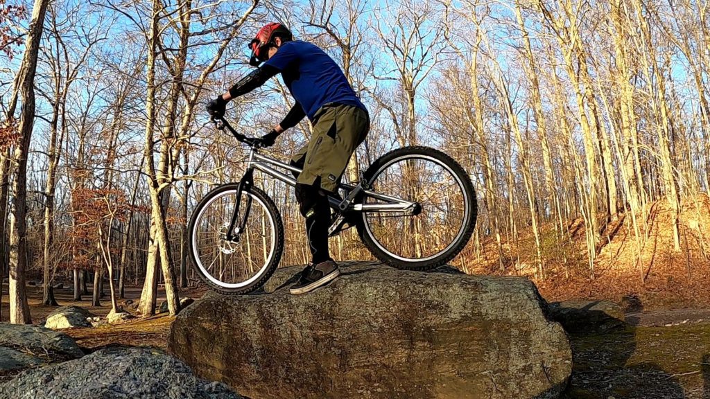 Scott on his trials bike on top of a boulder