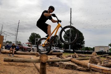 Nathaniel Moore prepares to gap between logs at the 2022 Bentonville Bike Fest