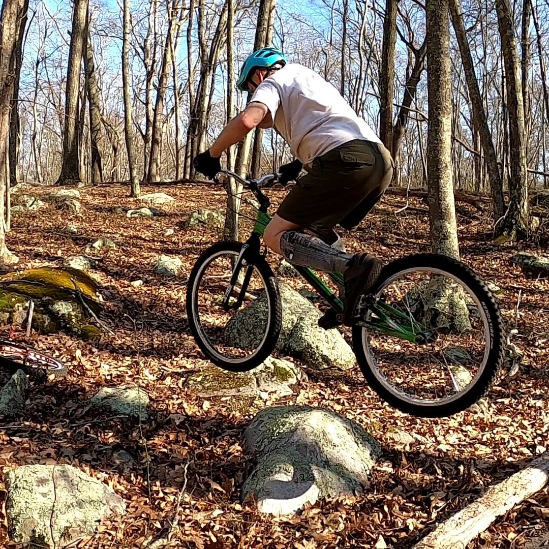 Jim appears to hover on his bike as he hops across some rocks