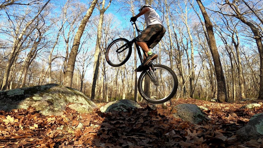 Tony hops his trials bike across some rocks