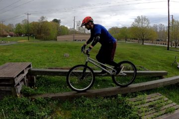 Scott rides a wet skinny beam on his trials bike