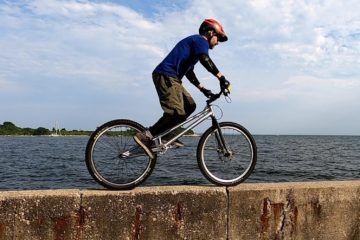 Biking on a narrow sea wall