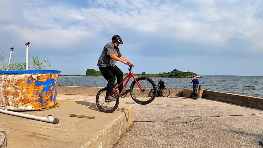 Preparing to rear wheel drop off a concrete ledge