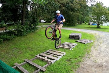 Rear wheel hopping across pallets on a trials bike