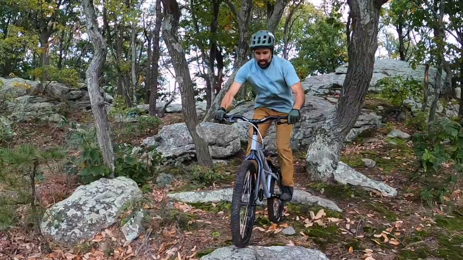 Jose pivots his front wheel up to the rock