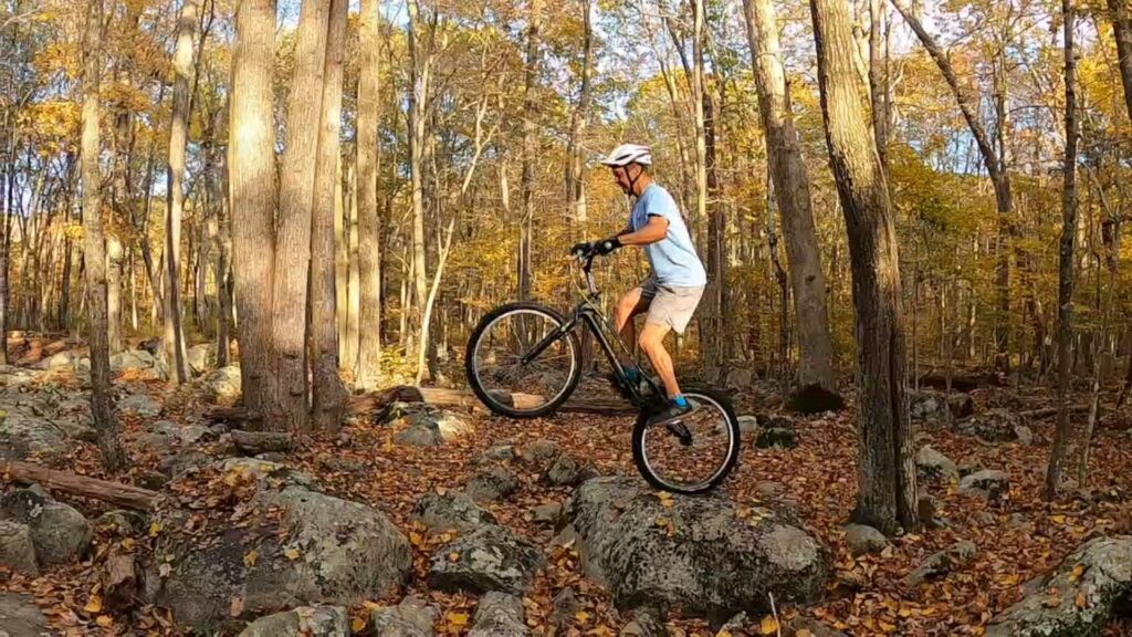 Tony hops his trials bike across some rocks