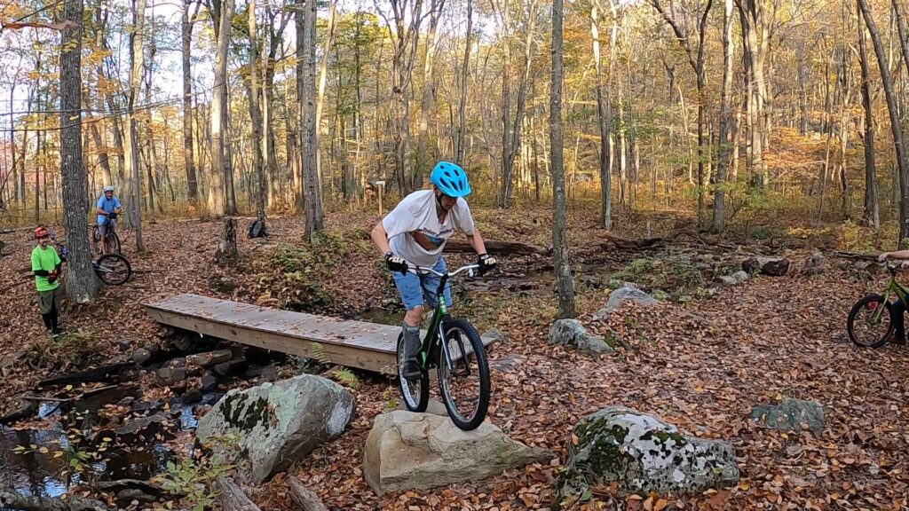 Jim balances atop a rock on his trials bike