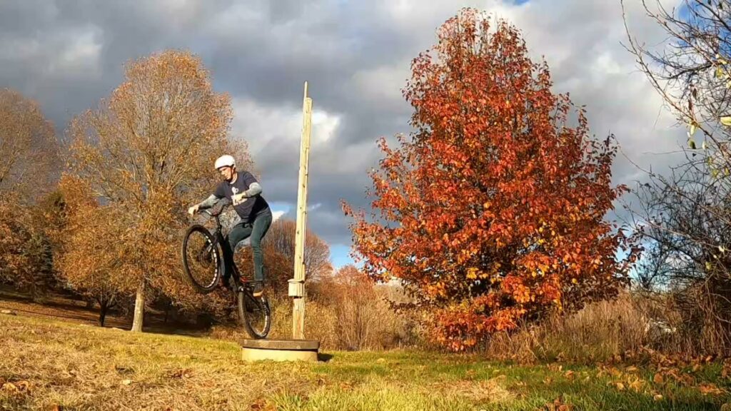 Dropping off a concrete well cover on my trials bike
