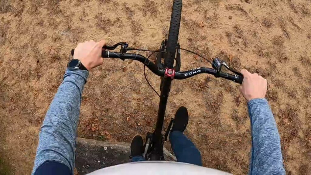 Rider POV: rear wheel drop from a rock