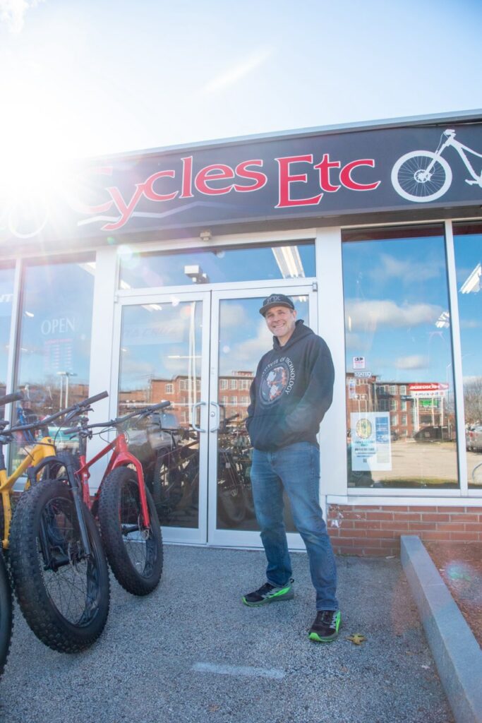 Bob Beal in front of the Cycles Etc bike shop