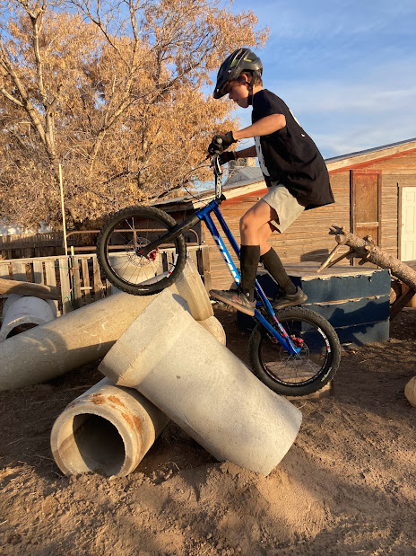 Grant rides his trials bike up a concrete pipe