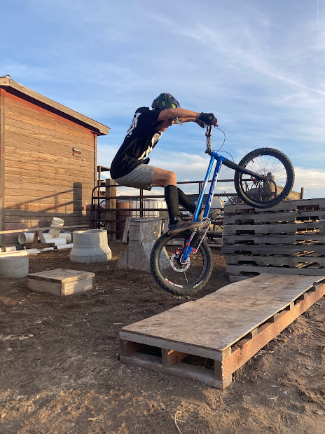 Trials bike hop to wooden platform