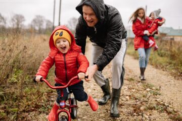 Father teaches son how to ride a bike